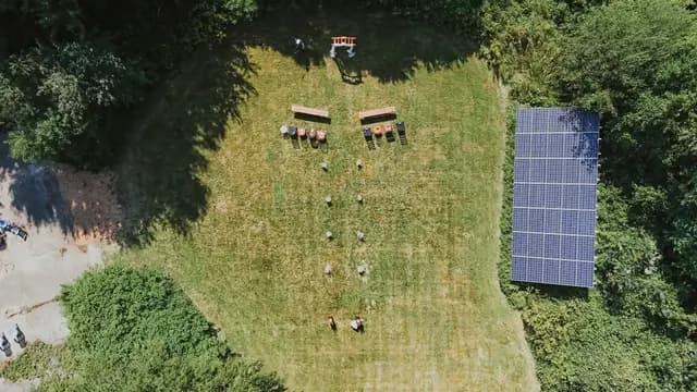 Aerial view of the outdoor ceremony site with rows of benches by solar panels