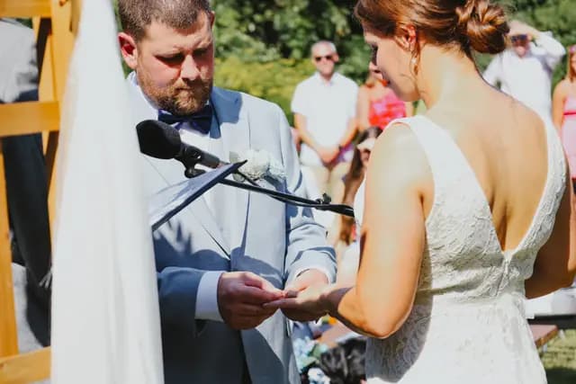 Groom places the ring on the bride's finger during the ceremony