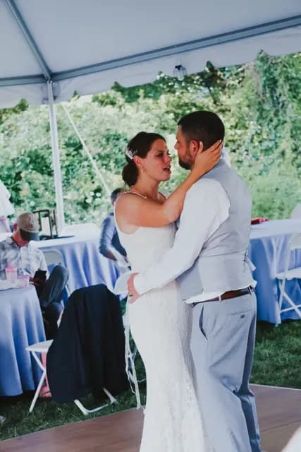 Bride and groom share their first dance under the reception tent