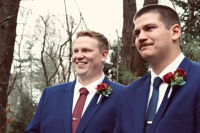 Groom and best man glance aside in a candid moment