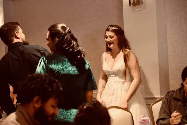 Bride shares a laugh with friends during the reception
