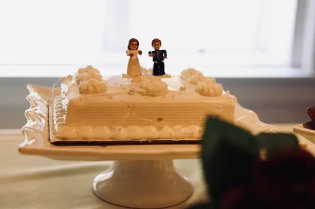 White wedding cake topped with Lego bride and groom figures
