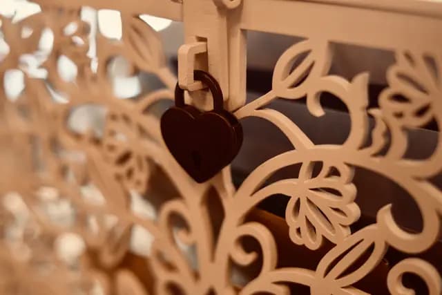 Heart-shaped padlock hanging on a laser-cut wooden lantern