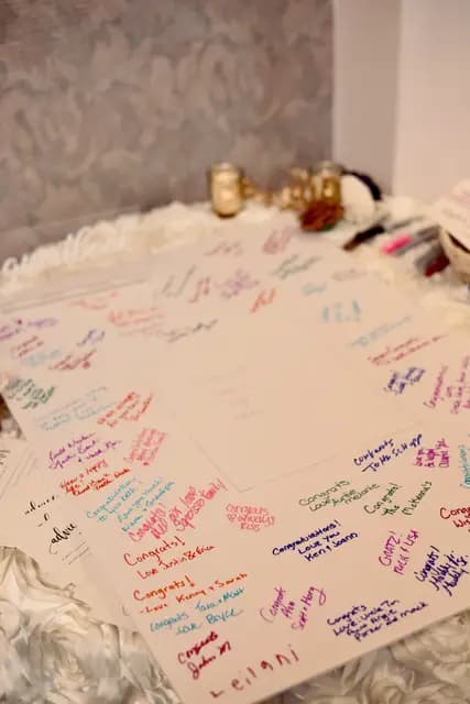 Guest board covered in handwritten congratulations from guests