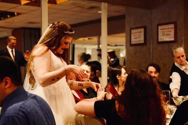 Bride greets seated guests as dinner is served