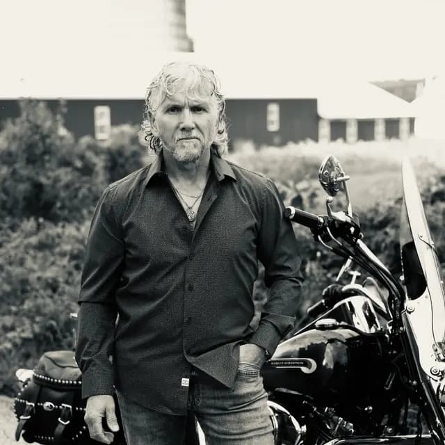 Black and white stare-down by the motorcycle