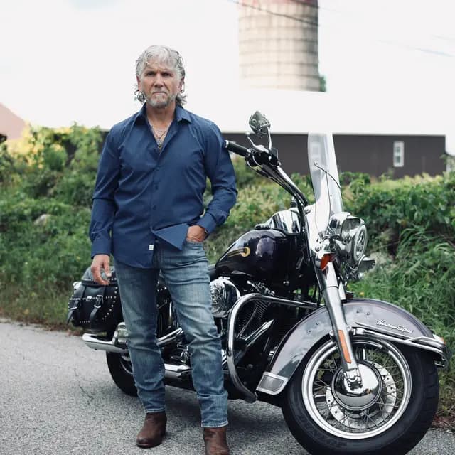 Navy shirt and jeans beside the Heritage Softail