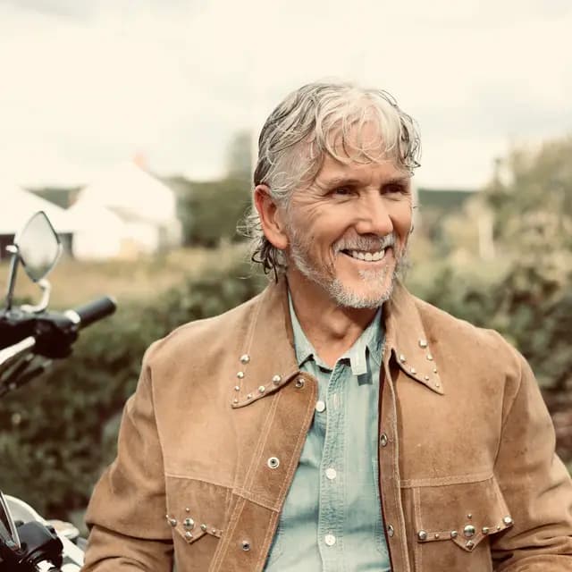 Warm-toned grin looking off to the fields