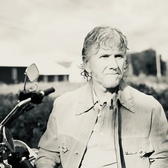 Black and white direct portrait by the handlebars