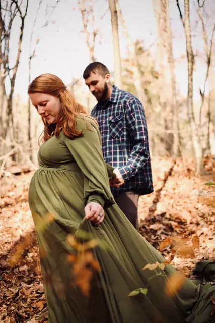 The couple wanders the leafy trail hand in hand