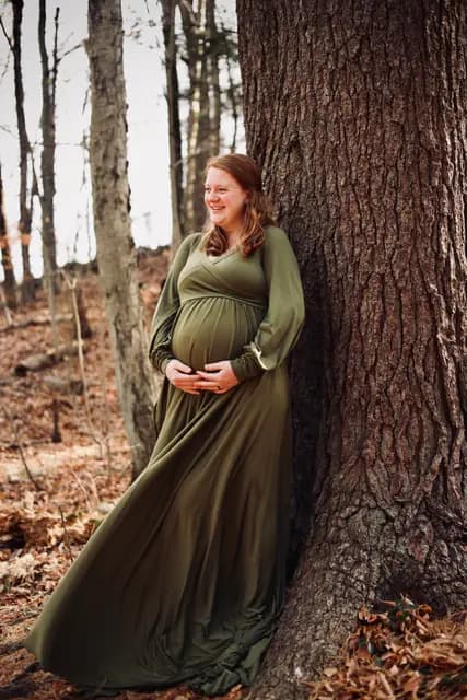 Laughing against the oak as the gown fans over the leaves