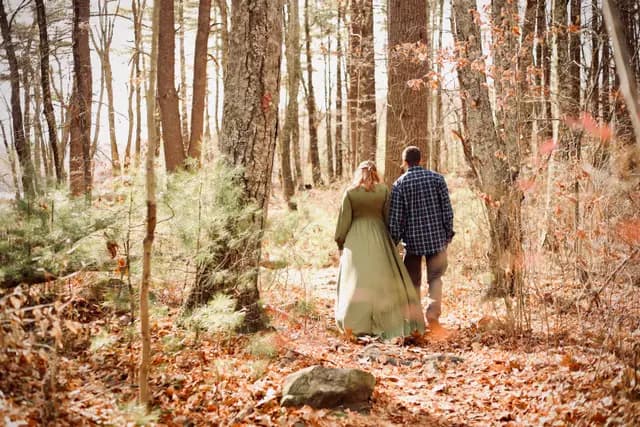 Walking the pine trail together, her gown catching the light