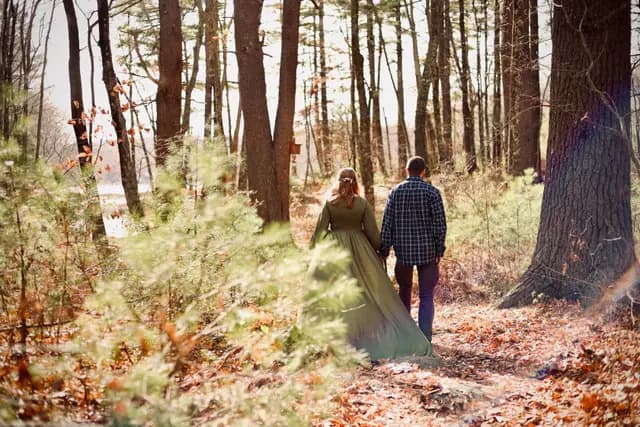 Hand in hand past the pines toward the water
