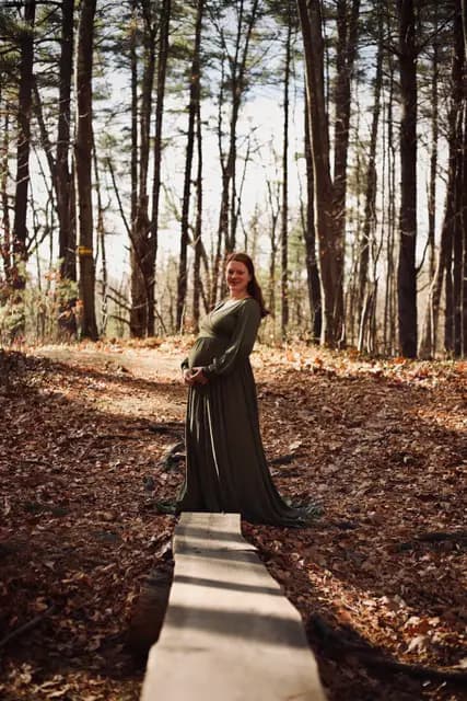 A smile back down the plank path through tall pines